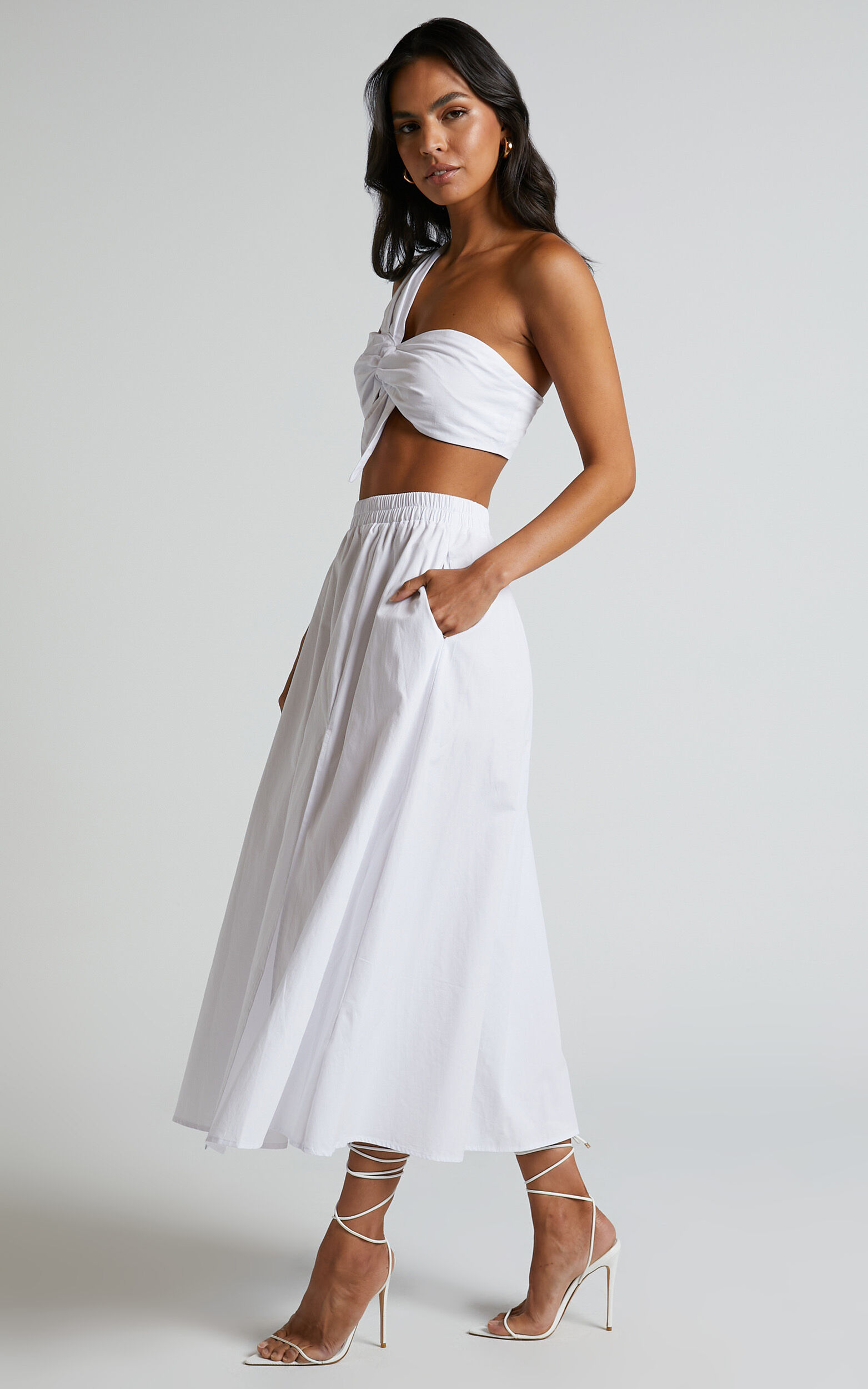 https://www.showpo.com/dw/image/v2/BDPQ_PRD/on/demandware.static/-/Sites-sp-master-catalog/default/dw6c8f475d/images/sula-one-shoulder-bralette-and-midi-skirt-two-piece-set-SC22090009/Sula_Two_Piece_Set_-_One_Shoulder_Bralette_Crop_Top_and_Midi_Skirt_in_White_26.jpg?sw=1563&sh=2500