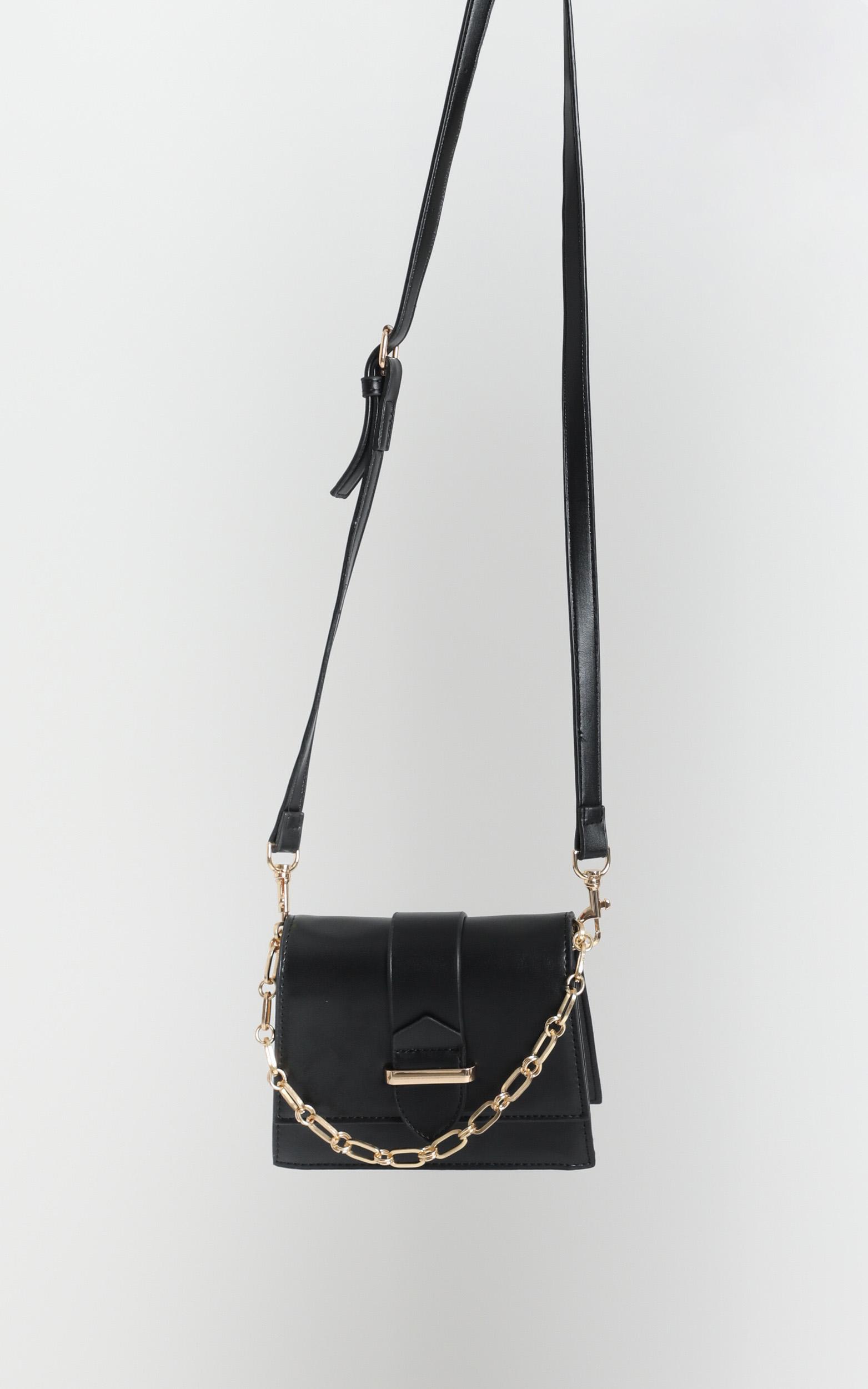 black and gold sling bag